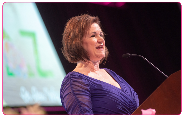Michelle Albrecht Smith gives speech at podium at Delta Zeta event