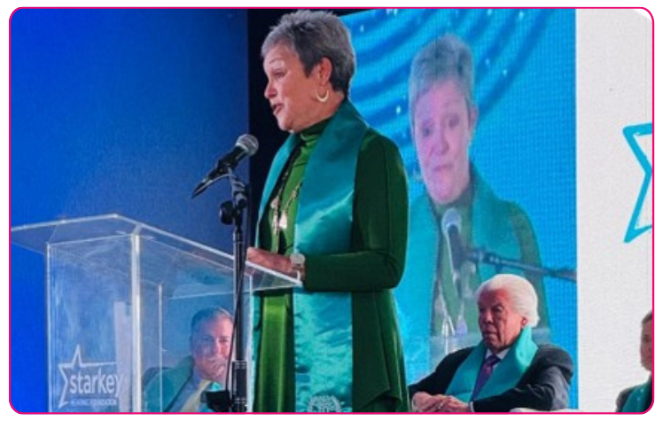 Cindy Winslow Menges speaks at podium at Starkey fundraising event