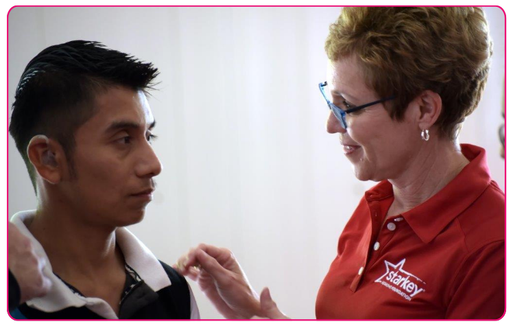 Cindy Winslow Menges talks to a young man on a Starkey Mission