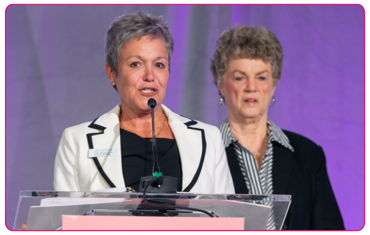 Cindy Winslow Menges gives speech  at podium at Delta Zeta event